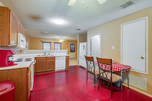 kitchen featuring sink, white appliances, a textured ceiling, and ceiling fan