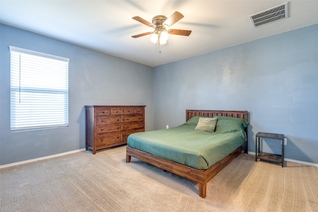 bedroom with ceiling fan and light carpet