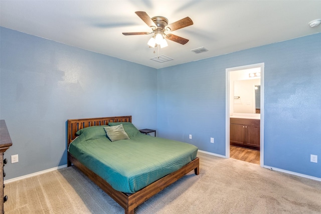 carpeted bedroom featuring ceiling fan and ensuite bath