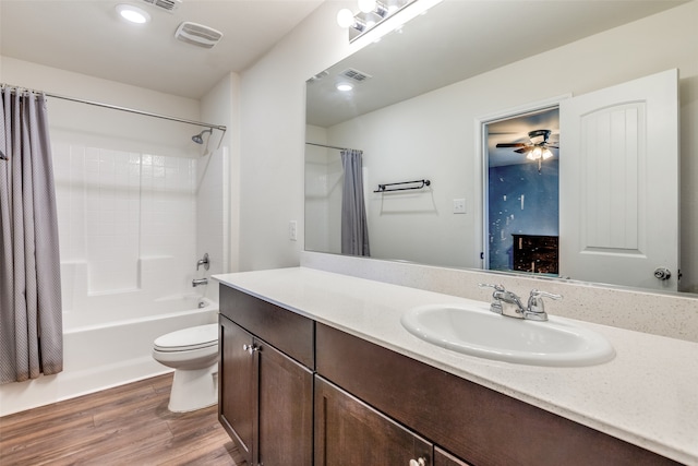 full bathroom featuring hardwood / wood-style floors, vanity, ceiling fan, toilet, and shower / bathtub combination with curtain