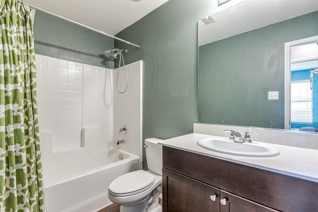 full bathroom featuring vanity, shower / bathtub combination with curtain, and toilet