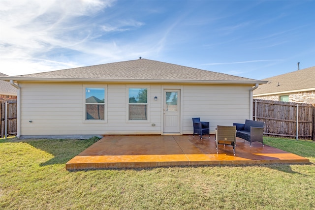 rear view of property featuring a patio area and a yard