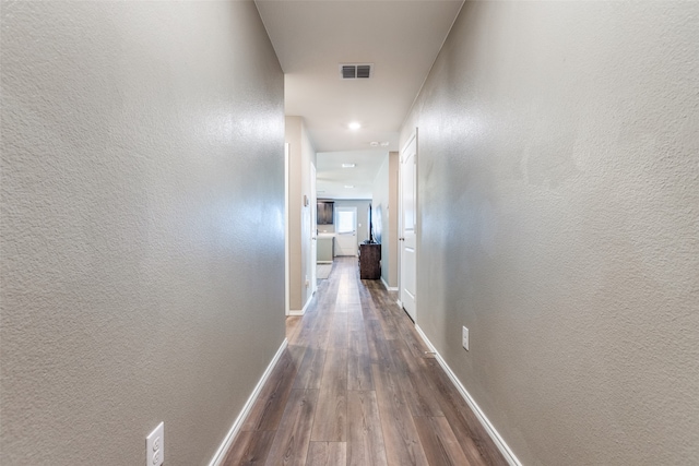 hallway with dark wood-type flooring