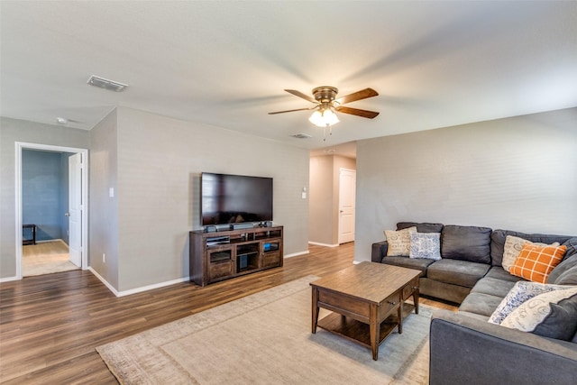 living room featuring ceiling fan and wood-type flooring