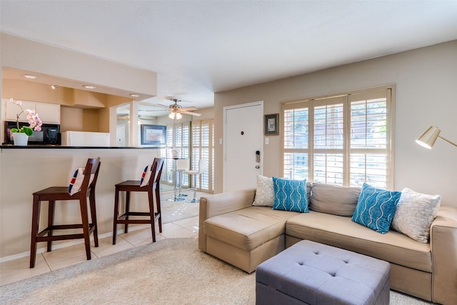 tiled living room featuring ceiling fan