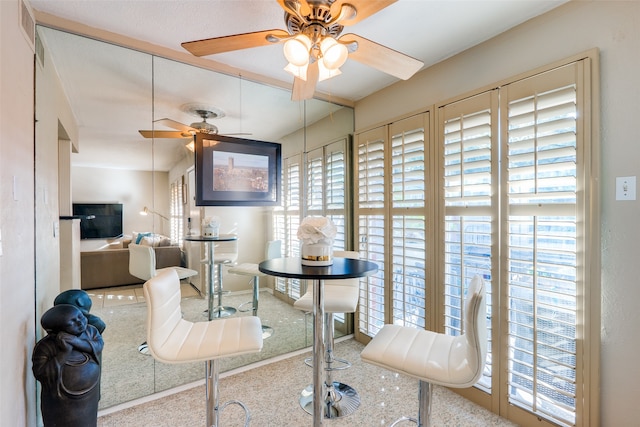 interior space featuring ceiling fan