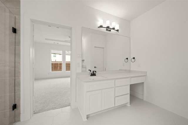 bathroom with walk in shower, vanity, and tile patterned flooring