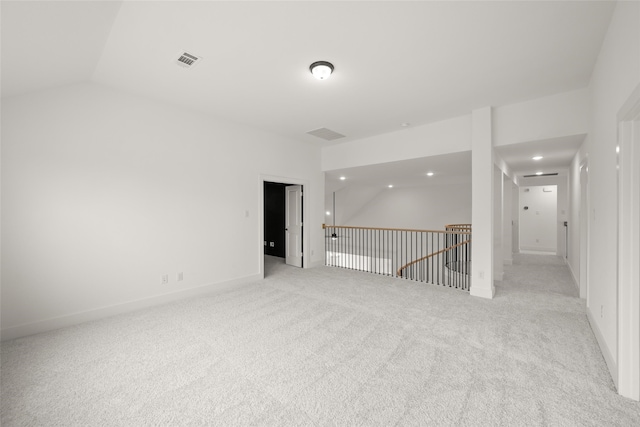 carpeted empty room featuring lofted ceiling