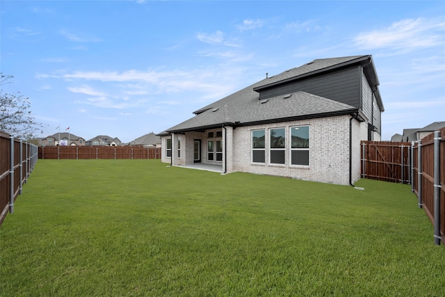 back of house featuring a patio area and a yard