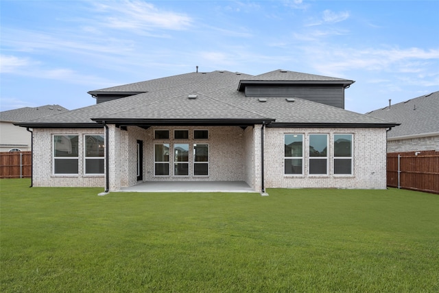 rear view of property with a patio and a yard