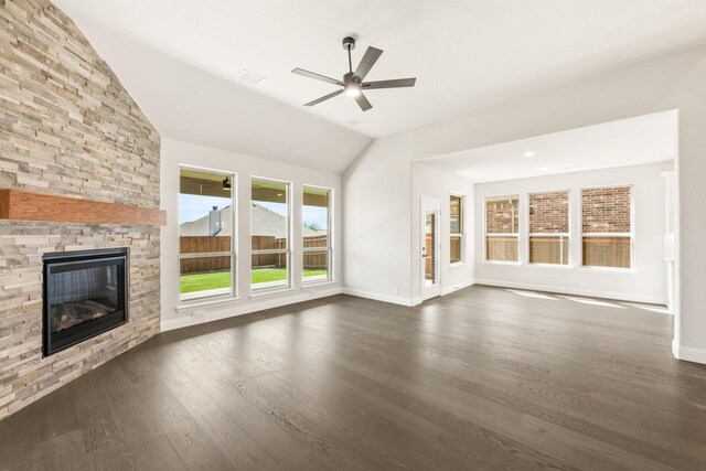 living room with light wood-type flooring, lofted ceiling, ceiling fan, and a fireplace