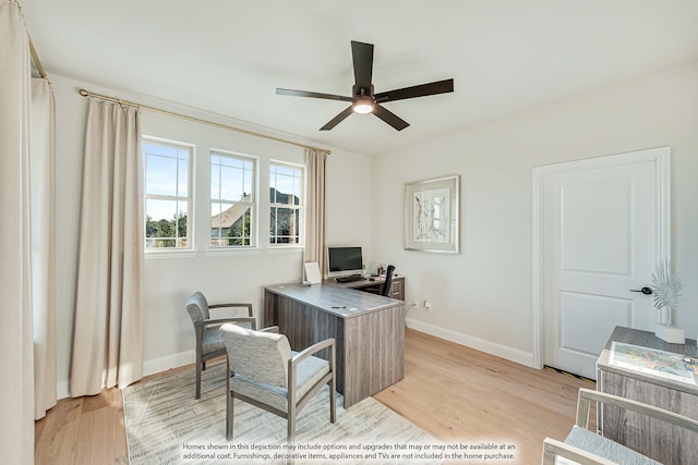 home office with light hardwood / wood-style floors and ceiling fan