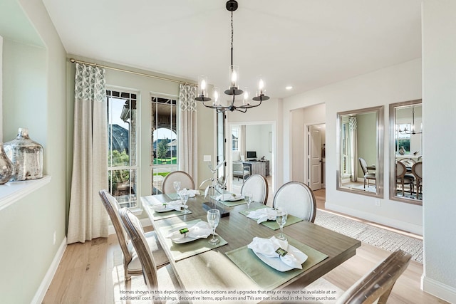 dining area featuring light hardwood / wood-style flooring and a notable chandelier