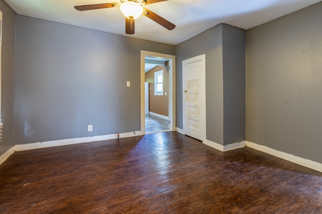 empty room featuring ceiling fan and dark hardwood / wood-style flooring