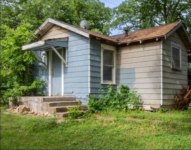 view of side of property with a yard