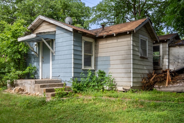 view of home's exterior with a yard