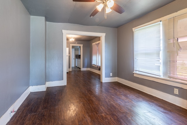 spare room with dark hardwood / wood-style flooring and ceiling fan