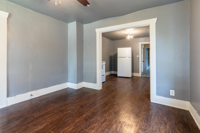 empty room featuring ceiling fan and dark wood-type flooring