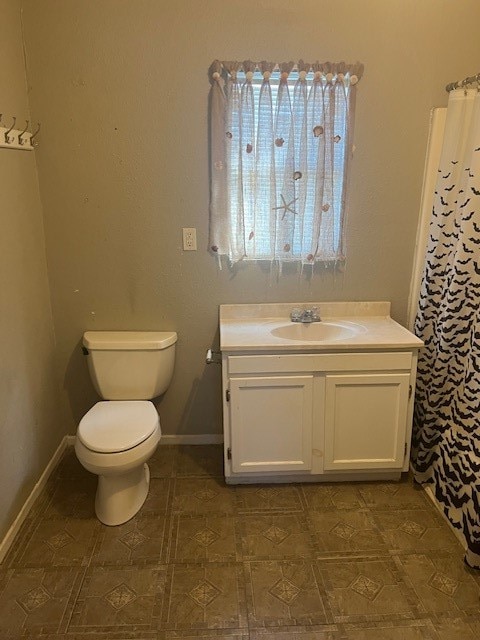 bathroom featuring toilet and vanity