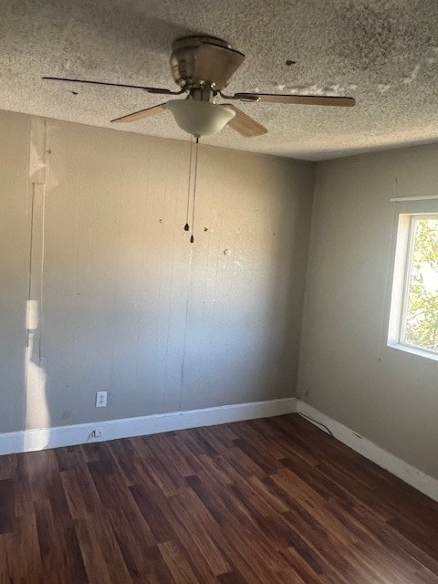 spare room with ceiling fan, a textured ceiling, and dark hardwood / wood-style flooring