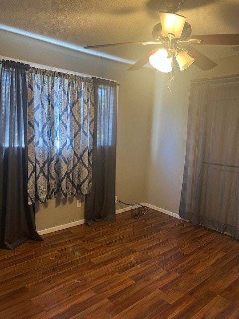 spare room featuring ceiling fan, a textured ceiling, and dark hardwood / wood-style flooring