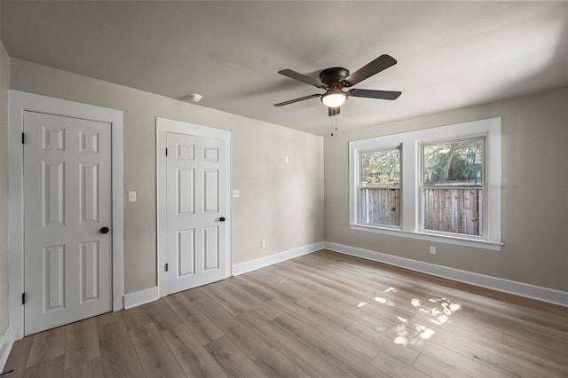 empty room with light hardwood / wood-style floors and ceiling fan