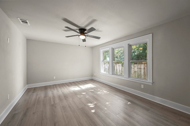 empty room with ceiling fan and wood-type flooring