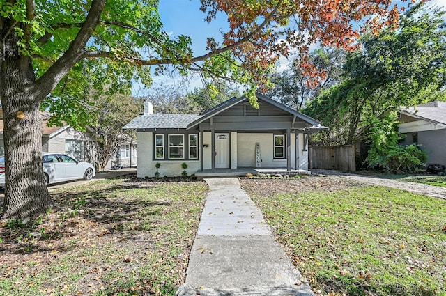 view of front facade with covered porch and a front lawn