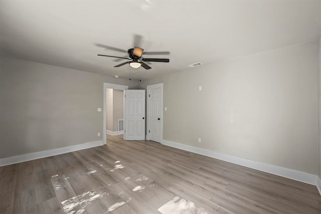 spare room featuring ceiling fan and light hardwood / wood-style flooring