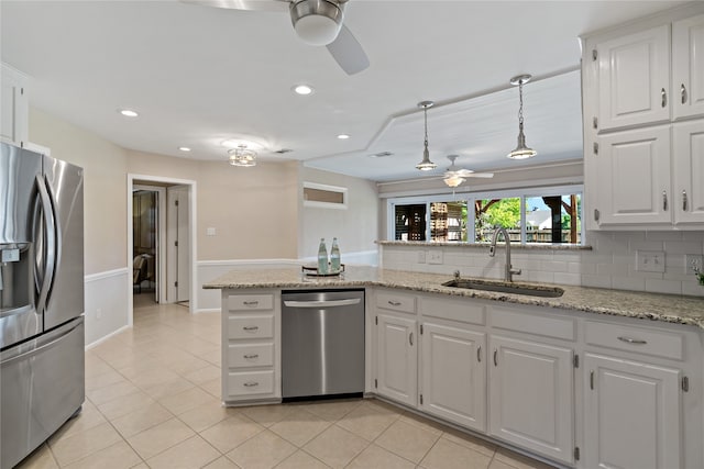 kitchen featuring kitchen peninsula, appliances with stainless steel finishes, white cabinetry, and sink