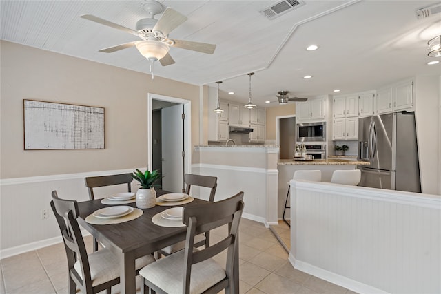 dining area with ceiling fan and light tile patterned floors