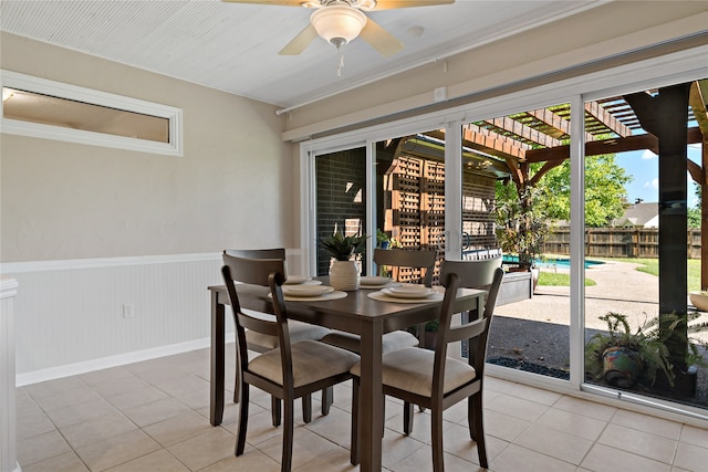 tiled dining space featuring ceiling fan