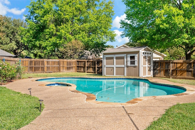 view of pool with an in ground hot tub and a shed