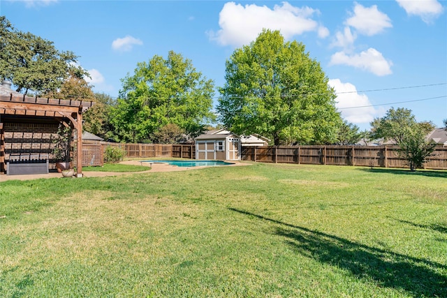 view of yard with an outbuilding and a fenced in pool