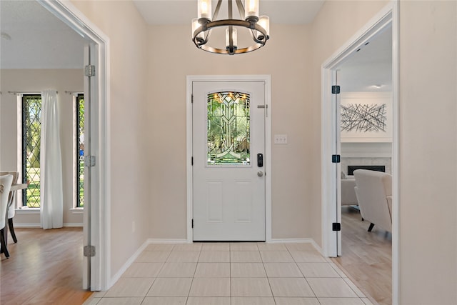 foyer entrance featuring a chandelier, light hardwood / wood-style floors, and plenty of natural light