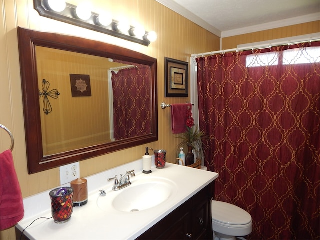 bathroom with a shower with shower curtain, vanity, toilet, and crown molding