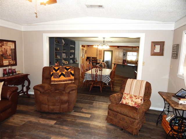 living room with dark wood-type flooring, a textured ceiling, lofted ceiling, and crown molding