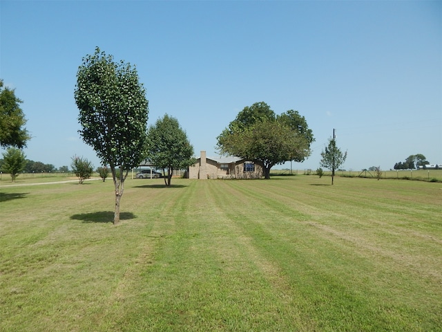 view of yard with a rural view