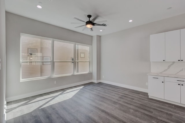 interior space with ceiling fan and dark hardwood / wood-style floors