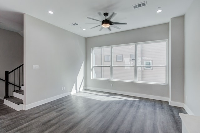 unfurnished living room featuring dark hardwood / wood-style flooring and ceiling fan