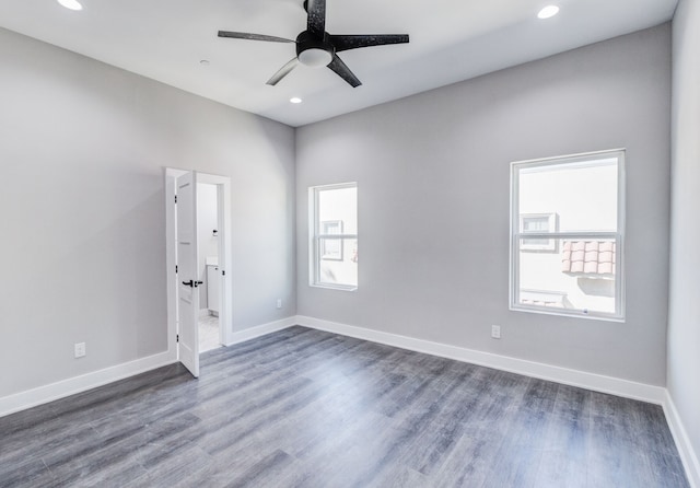 empty room featuring dark wood-type flooring and ceiling fan