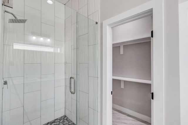 bathroom with a shower with door