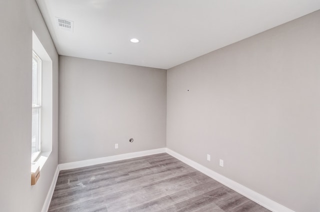 empty room with light hardwood / wood-style flooring