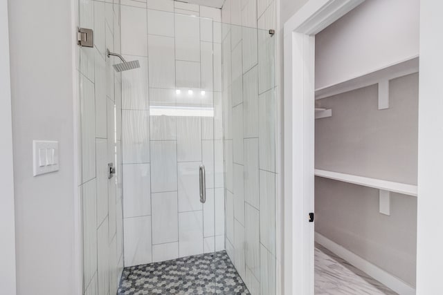 bathroom with a shower with door