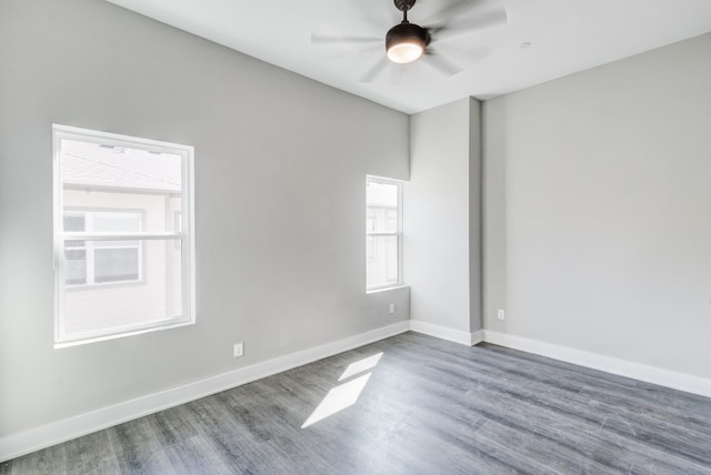 unfurnished room with dark wood-type flooring and ceiling fan