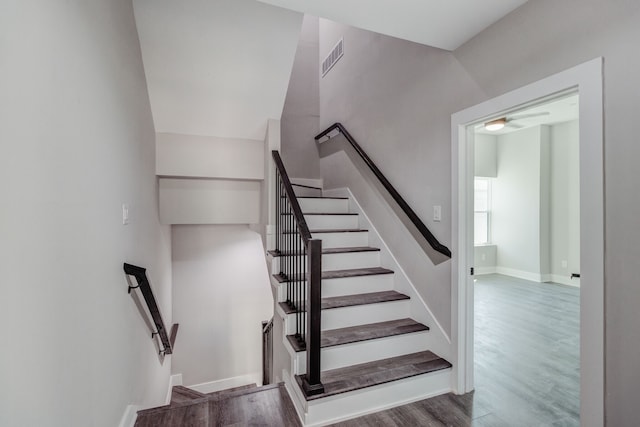 stairs featuring hardwood / wood-style floors