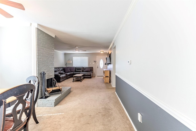 living room with light carpet, ceiling fan, and ornamental molding