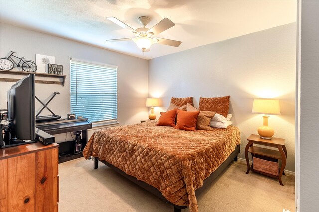 bedroom with light carpet and ceiling fan