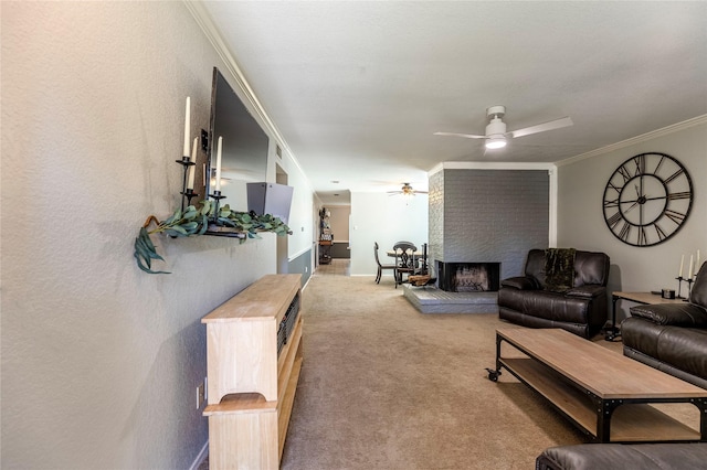 living room with carpet flooring, a brick fireplace, ceiling fan, and crown molding