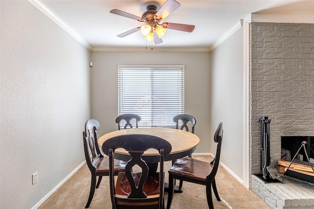 dining room featuring a brick fireplace, ceiling fan, light carpet, and ornamental molding